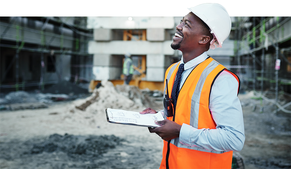 Photo of smiling man at construction site