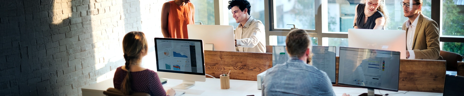 Image of employees working in an office environment with mini computers connected to business Internet service