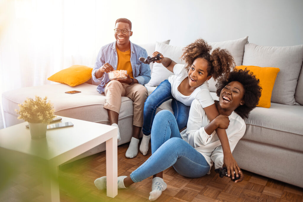 Family sitting together in the living room, enjoying broadband services from CDE Lightband