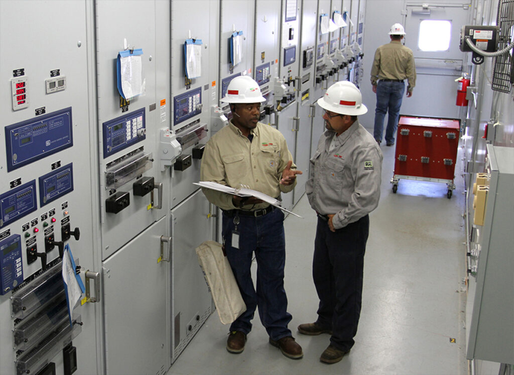 Image of professional engineers working on electrical component grid at CDE Lightband