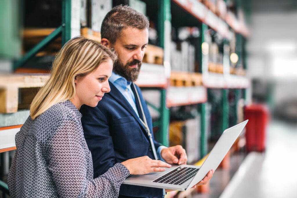 Staff working together in corporate warehouse on staff network business Internet