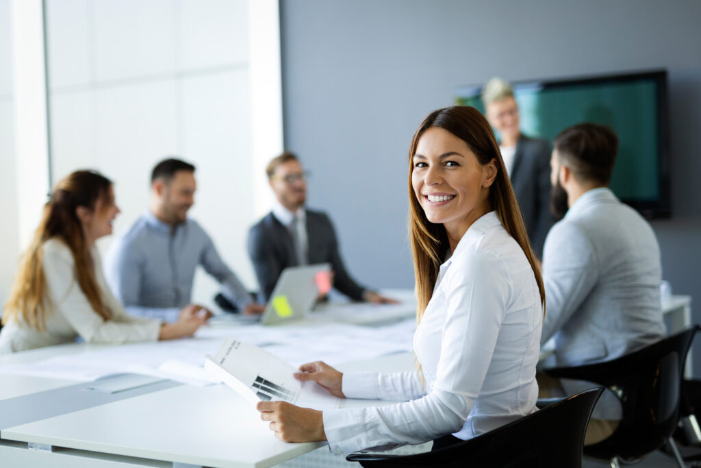 Image of women, smiling during business meeting at conference table