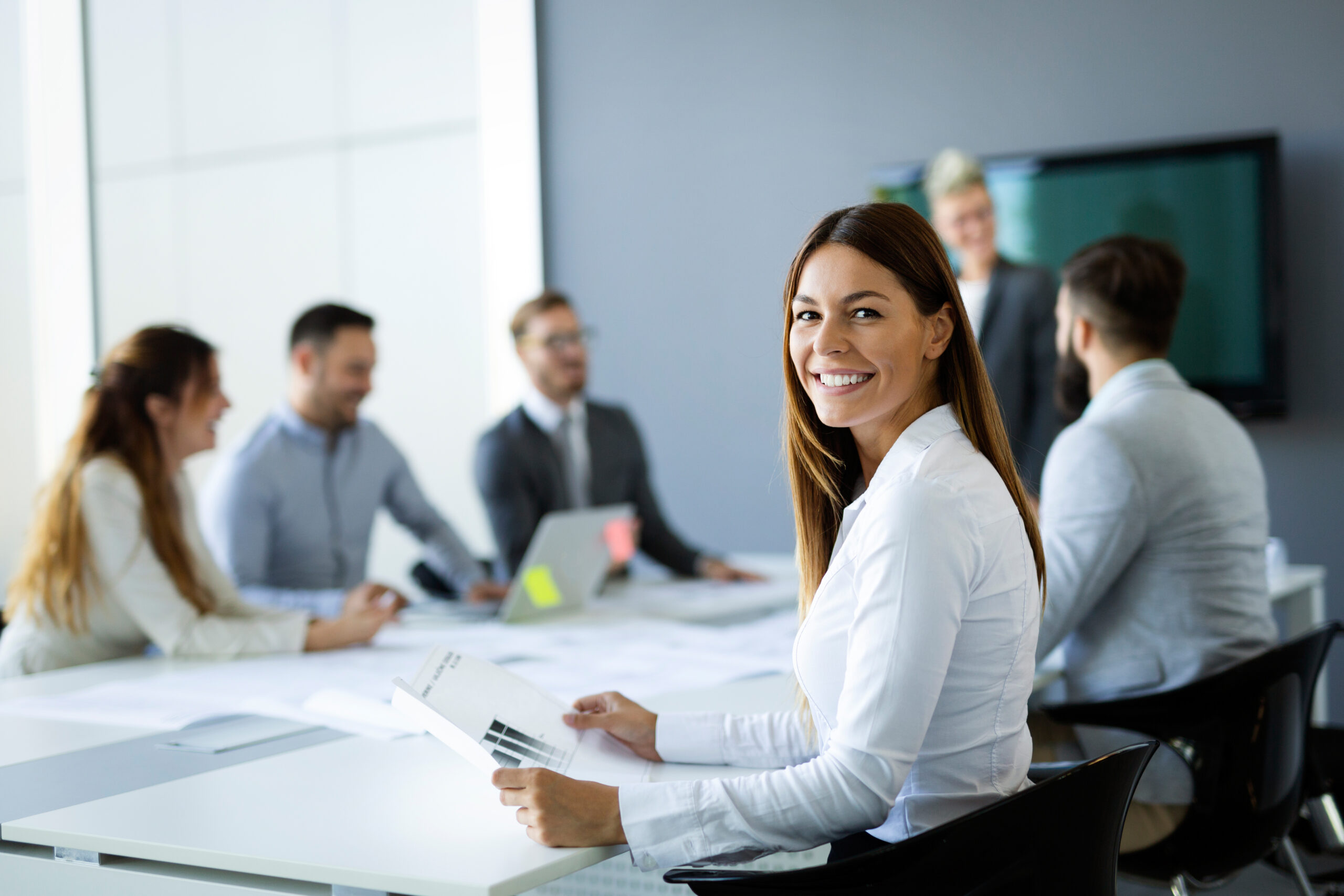 Image of businesswoman, smiling during conference meeting