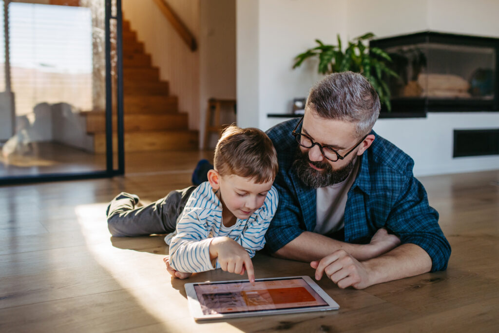 Image of man with his son using tablet device