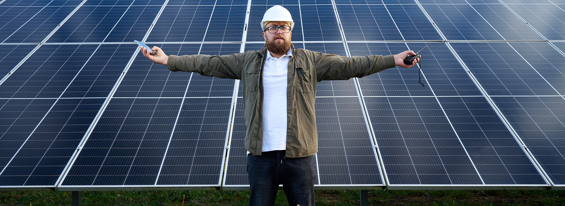 Image of man standing in front of solar panels